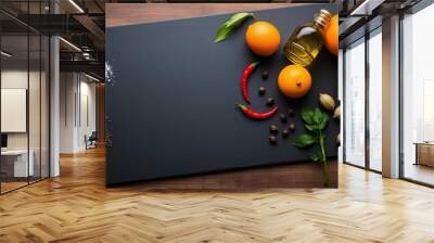 Dark slate board culinary ingredients fresh herbs citrus fruits background Wall mural