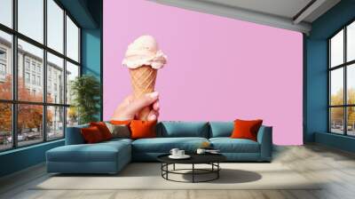 Woman holding waffle cone with delicious ice cream on light pink background, closeup. Copy space. Generative AI. Wall mural