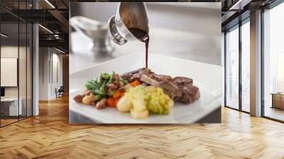 Chef plating up food in a restaurant Wall mural