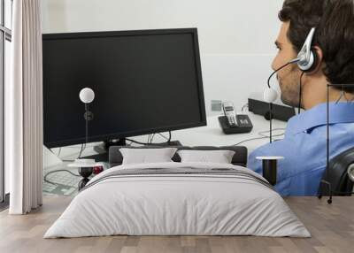 Man wearing headset giving online chat and support Wall mural