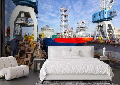 A cargo ship is building in a dock at a shipyard Wall mural