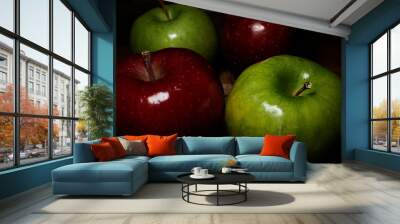 Four two red and two green apples on wooden table and dark background Wall mural