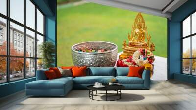 Flower garlands, water bowls, perfume and white clay filler for Buddha bathing ceremony on important religious days for Buddhists, New Year's and Songkran Festivals for Asians. Wall mural