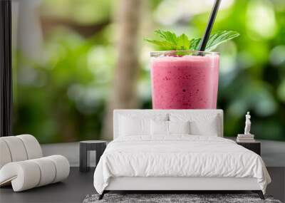 Fresh pink smoothie in a glass with a straw Wall mural