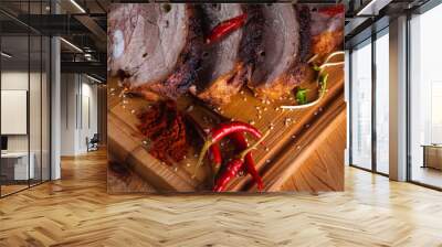 delicious, juicy and fragrant grilled pork, ribs on a wooden board on a dark background with hot red pepper and spices. Delicious meat concept Wall mural