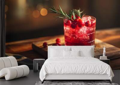 A glass of red cranberry juice is on a wooden table with a bunch of cranberries  Wall mural