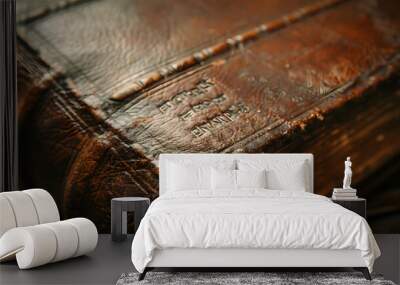 A leather bound book with gold embossing on the spine Wall mural