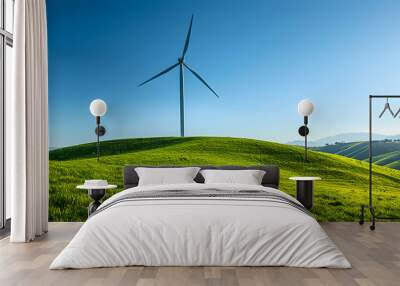 A wind turbine is standing in a field of grass Wall mural