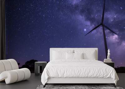 A wind turbine is standing in a field of stars Wall mural