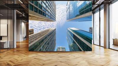 Between tall city buildings looking up on a sunny day, ground point of view Wall mural