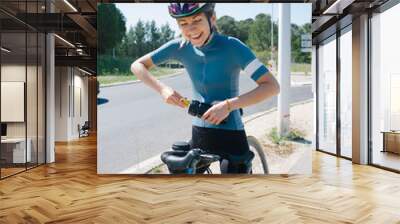 Female cyclist smiles happy on bike ride laughing Wall mural