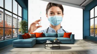 Beautiful female doctor with medical mask. Portrait of nurse with syringe in her hand... Wall mural