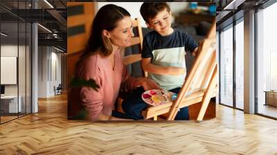 Beautiful woman and boy painting. Little boy drawing with mom in living room. Wall mural