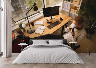 Businessman in office taking a break Wall mural