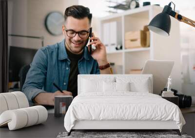 Businessman in office. Handsome man talking on phone at work.	
 Wall mural