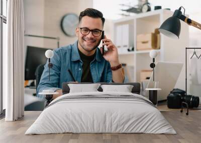 Businessman in office. Handsome man talking on phone at work. Wall mural