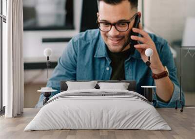 Businessman in office. Handsome man talking on phone at work.	
 Wall mural