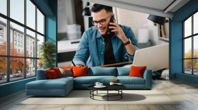 Businessman in office. Handsome man talking on phone at work.	 Wall mural