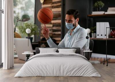 Businessman with medical mask. Handsome businessman having fun while working in office... Wall mural