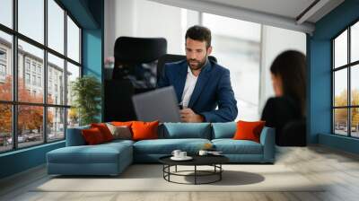 Businessman working on a project in the office. Young businessman working in office. Wall mural