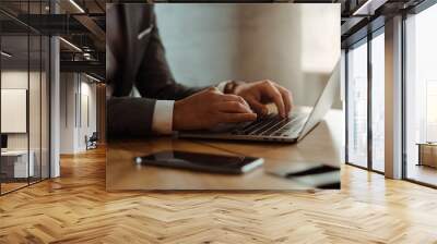 Businessman working on laptop in office Wall mural