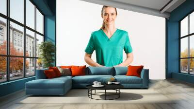 Cheerful female doctor in green uniform. Wall mural