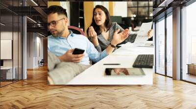 Colleagues arguing in office. Angry businesswpman yelling at her collegue.. Wall mural