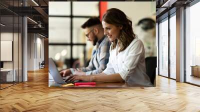 Colleagues in office. Businesswoman and businessman discussing work in office. Wall mural