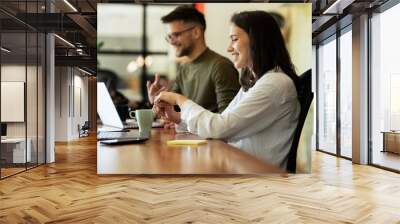 Colleagues in office. Businesswoman and businessman working on the project Wall mural