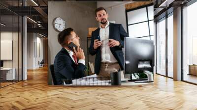 Colleagues in office. Two businessman discussing work in office.. Wall mural