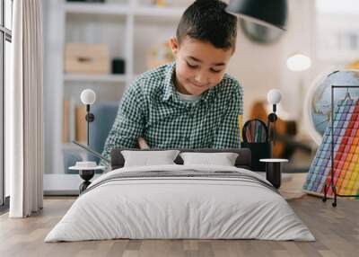 Cute little boy doing homework. Child learning foe school. Wall mural