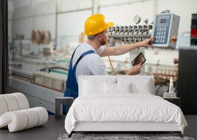 Factory worker. Man with helmet working with pvc. Wall mural