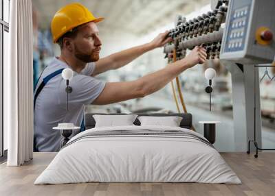 Factory worker. Man with helmet working with pvc. Wall mural