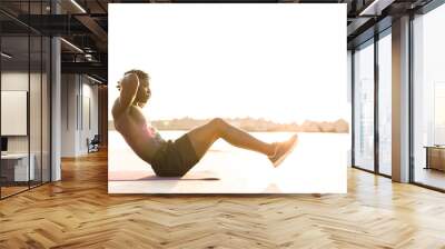 Fitness training outdoors. Handsome African man doing exercises outside. Muscular man training. Wall mural