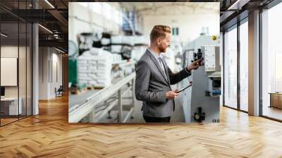 Manager checks machines at the factory.  Inspector checks a factory.  Supervisor runs his daily check at work. Factory worker setting the tech up for work. Wall mural