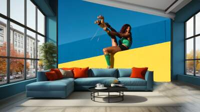 Urban woman enjoy outside. Modern woman posing with roller skates. Wall mural