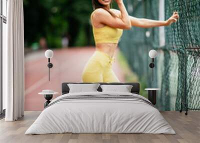 Young sporty woman on running track. Beautiful woman in sportswear. Wall mural