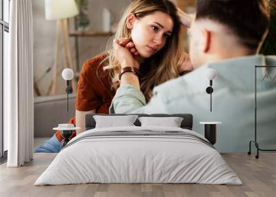 Young woman having a problem. Boyfriend comforting his sad girlfriend. Wall mural