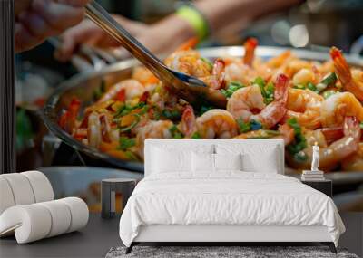 A close-up view of a pan filled with cooked shrimp and assorted ingredients, showcasing a delicious seafood dish. Wall mural