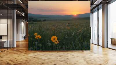 A dusky sunset casting an orange glow over an endless landscape of wildflower fields.. Wall mural