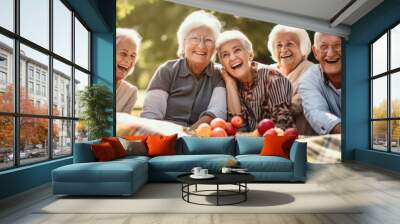 A group of elderly members lounging on a picnic blanket, reminiscing about old times and forming new friendships. Wall mural