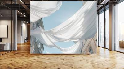 A large banner of soft flowing fabric hangs between two old buildings creating a mesmerizing contrast of textures. Wall mural