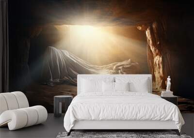 Concept photo of the empty tomb, with Jesus shroud discarded on the ground and a bright light shining from inside, symbolizing his resurrection. Wall mural