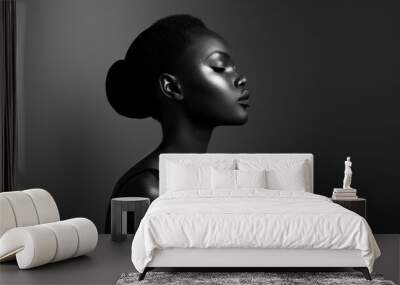 In a classic black and white portrait a poised black woman embraces the elegance of timeless fashion. The monochrome tones draw attention to the fine details and clean lines of her . Wall mural