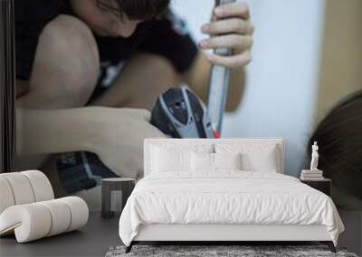 A young boy of 12 years old is learning to assemble furniture. Wall mural