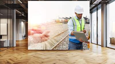 Rail logistics specialists engineers are working on the train tracks. Wall mural