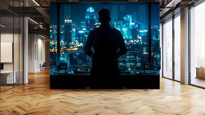 A man is standing in front of a computer monitor with a city view in the backgro Wall mural