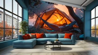 A tropical camp with hammocks and tents located in the shade of palm trees and surrounded by gre Wall mural