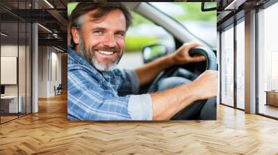 Man smiling while driving in a car on a sunny day Wall mural