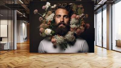 A man with a beard decorated with flowers isolated on grey background, studio shot, with copy space. Wall mural